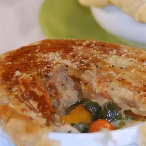 Close view of the filling with carrot and squash beneath a golden crust