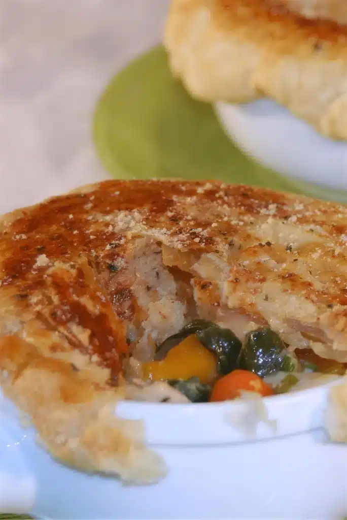 Close view of the filling with carrot and squash beneath a golden crust