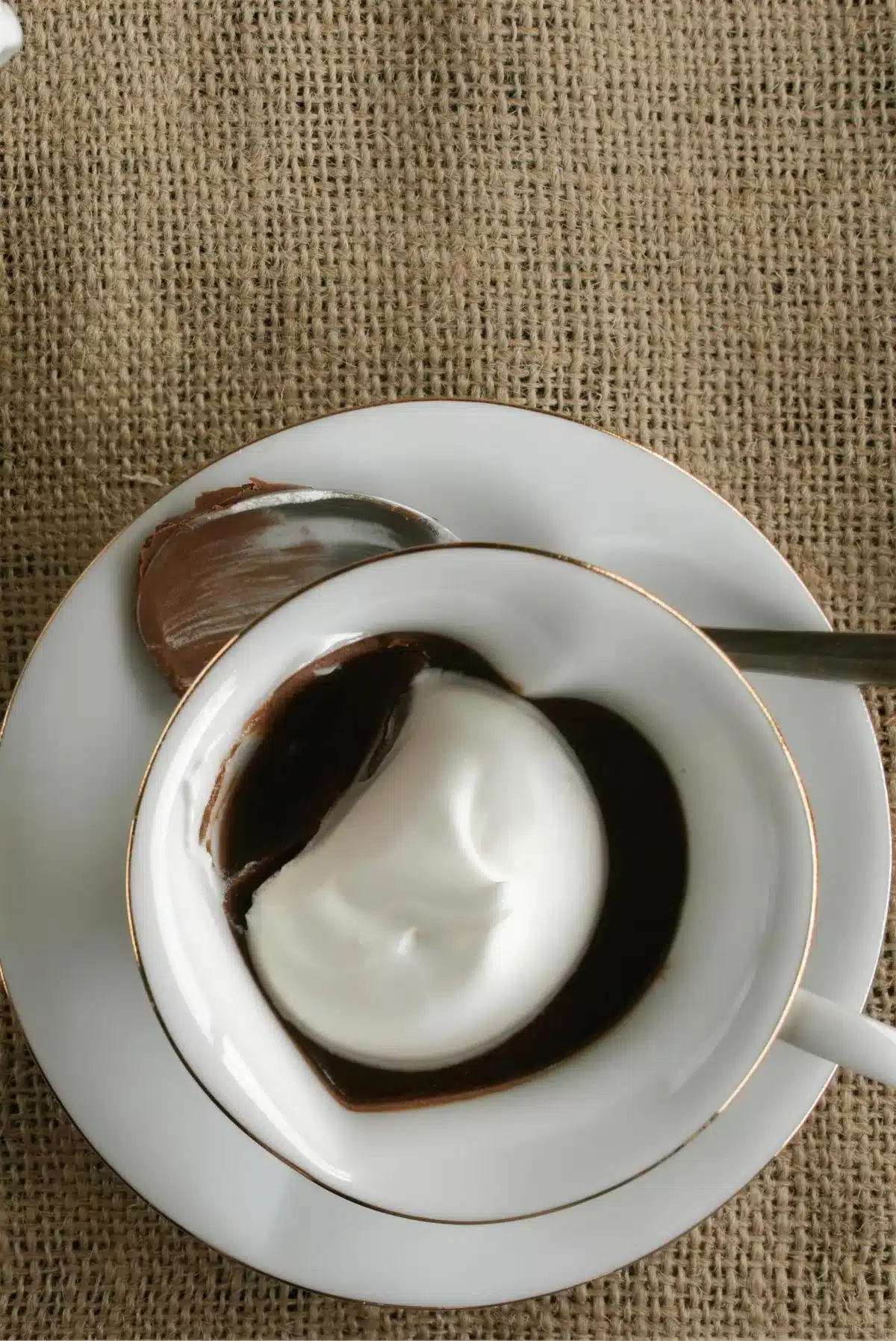 Chocolate pots de creme topped with a spoonful of whipped cream