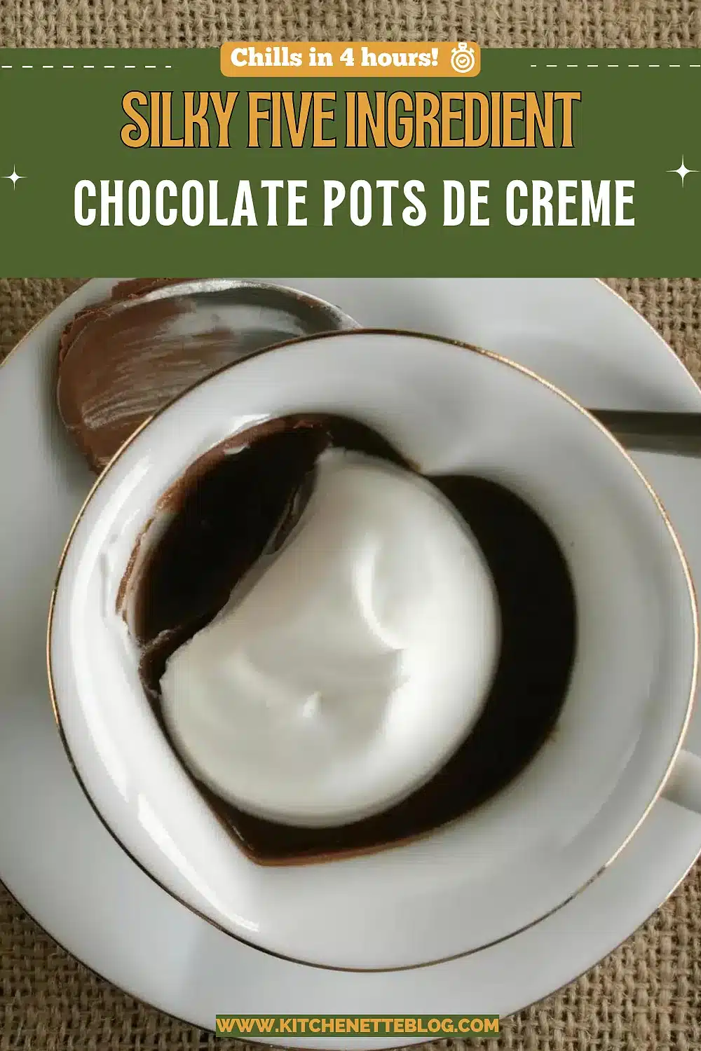 Dark custard in a gold rimmed cup topped with softly whipped cream