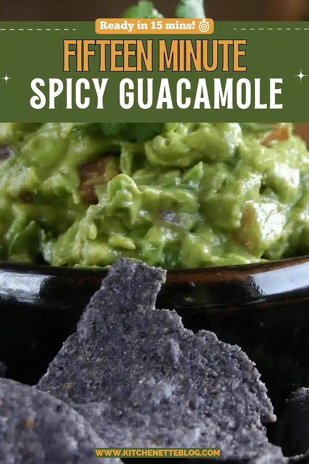 Chunky green avocado dip with cilantro beside blue corn chips