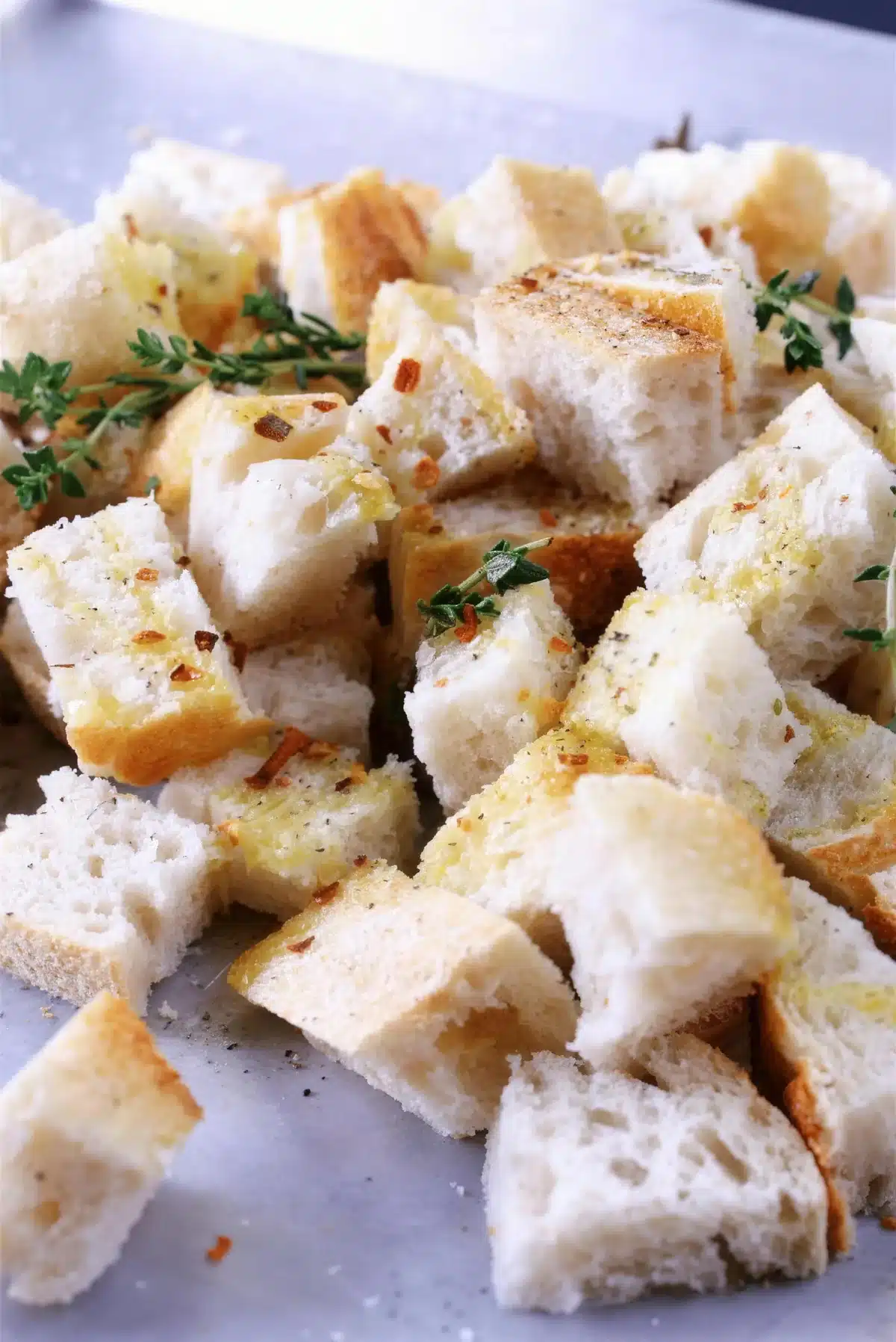 Sourdough croutons with thyme on a baking sheet for lemon caesar salad