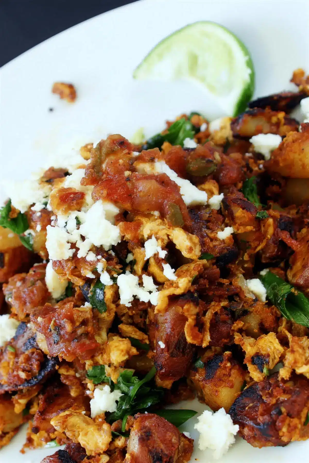 Chorizo hash close up with salsa, crumbled queso fresco and cilantro