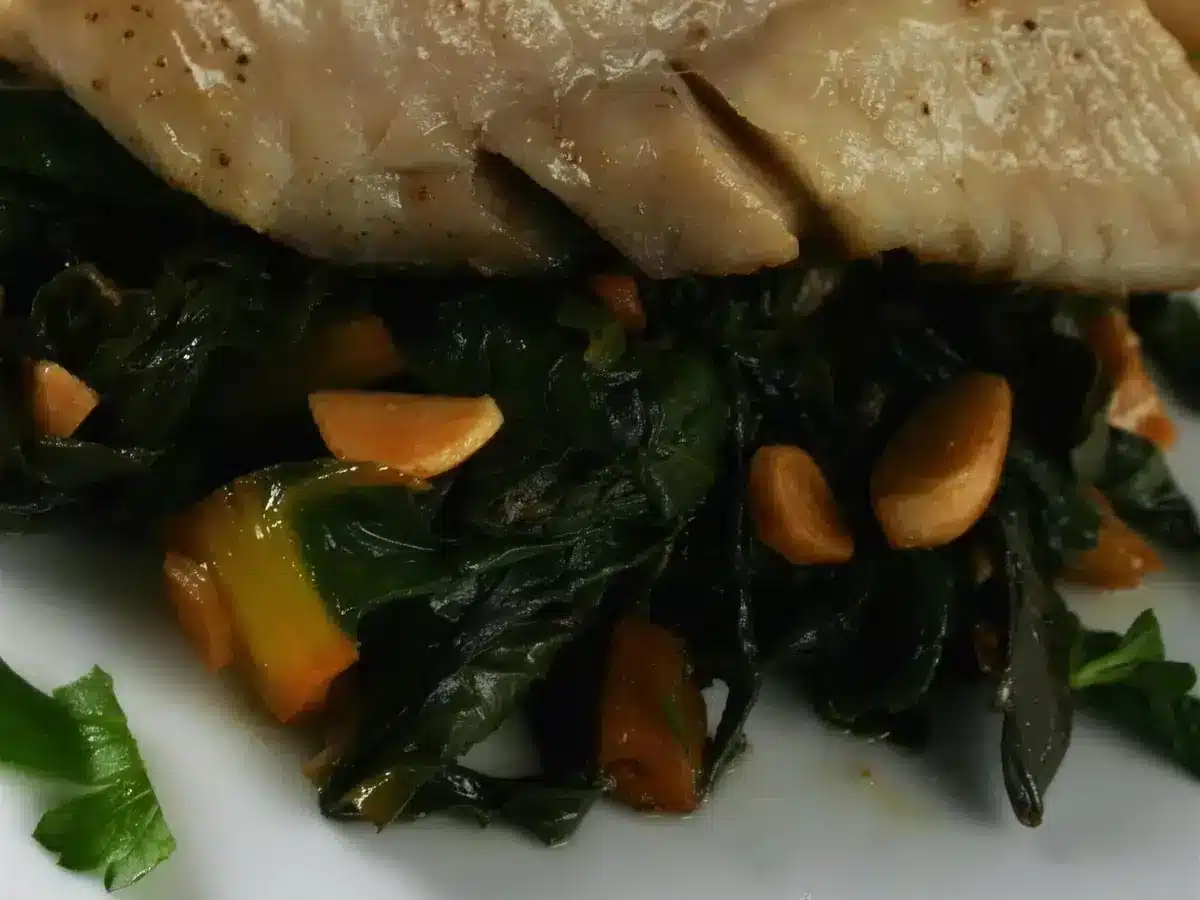 Garlicky rainbow chard and marcona almonds under the pan seared cod