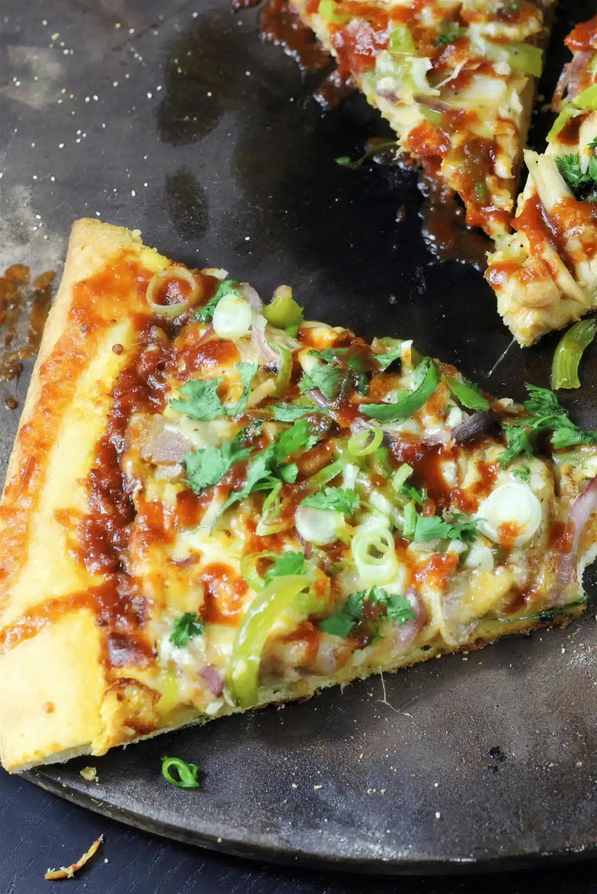 A slice lifted away with the cheese stretching behind it