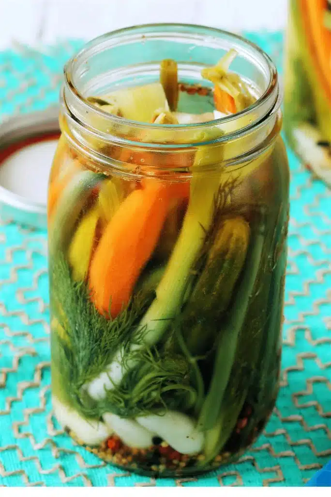 Pickled vegetables packed tightly into a quart jar with dill