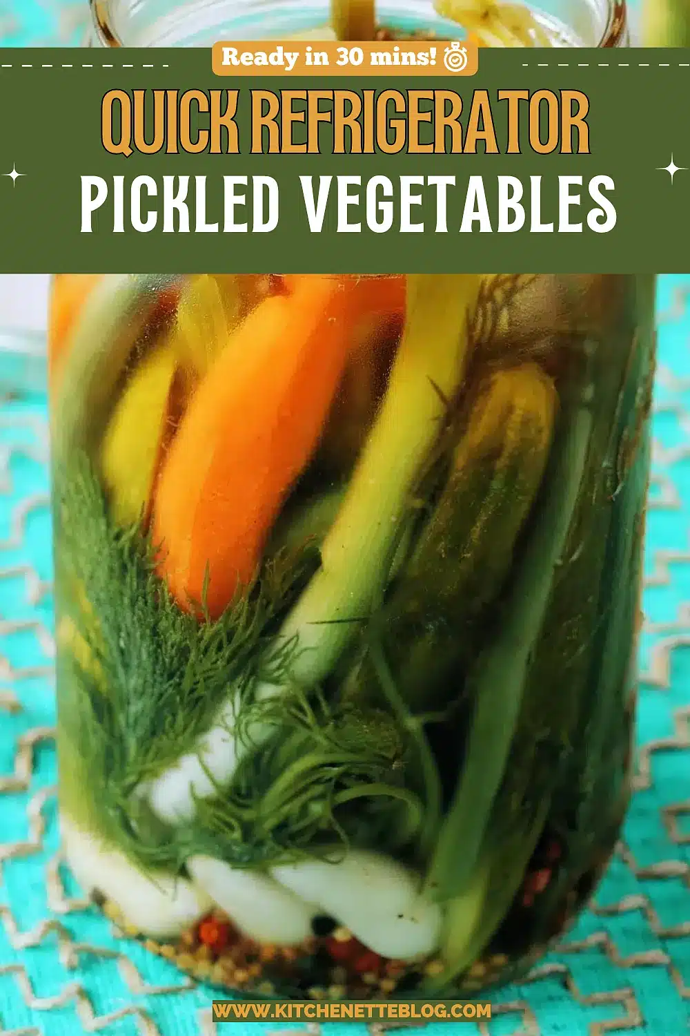 Tall jar packed with carrots, beans and dill in brine