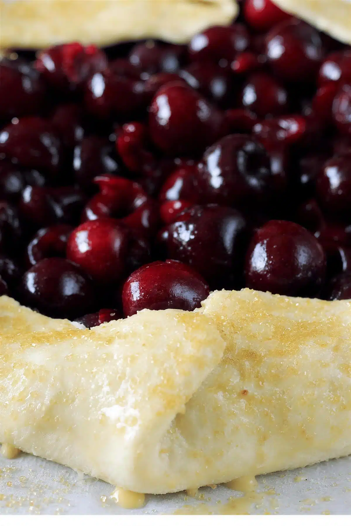 The dough border folded up over the raw fruit before baking, creases and all