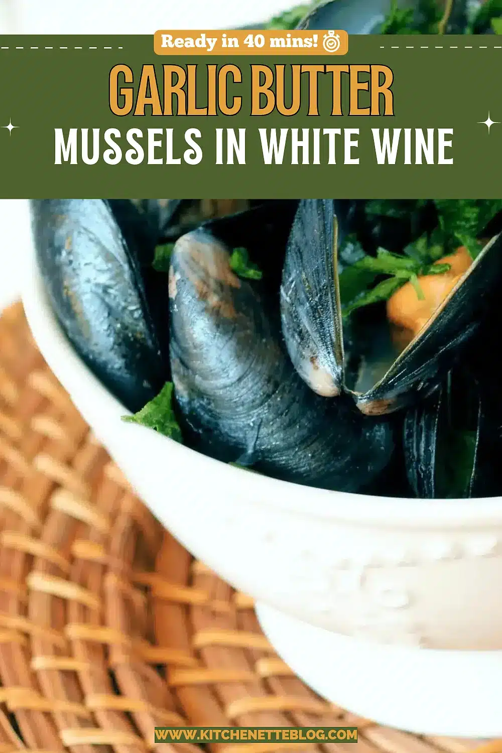 Bowl of steamed shellfish with parsley and crusty bread alongside