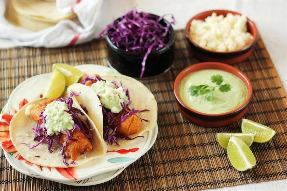 Beer battered fish tacos with red cabbage slaw, crema and queso fresco