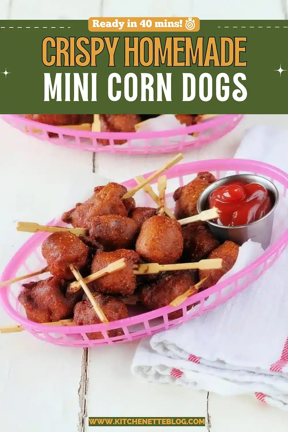 Battered sausage bites on skewers in pink baskets with ketchup and mustard