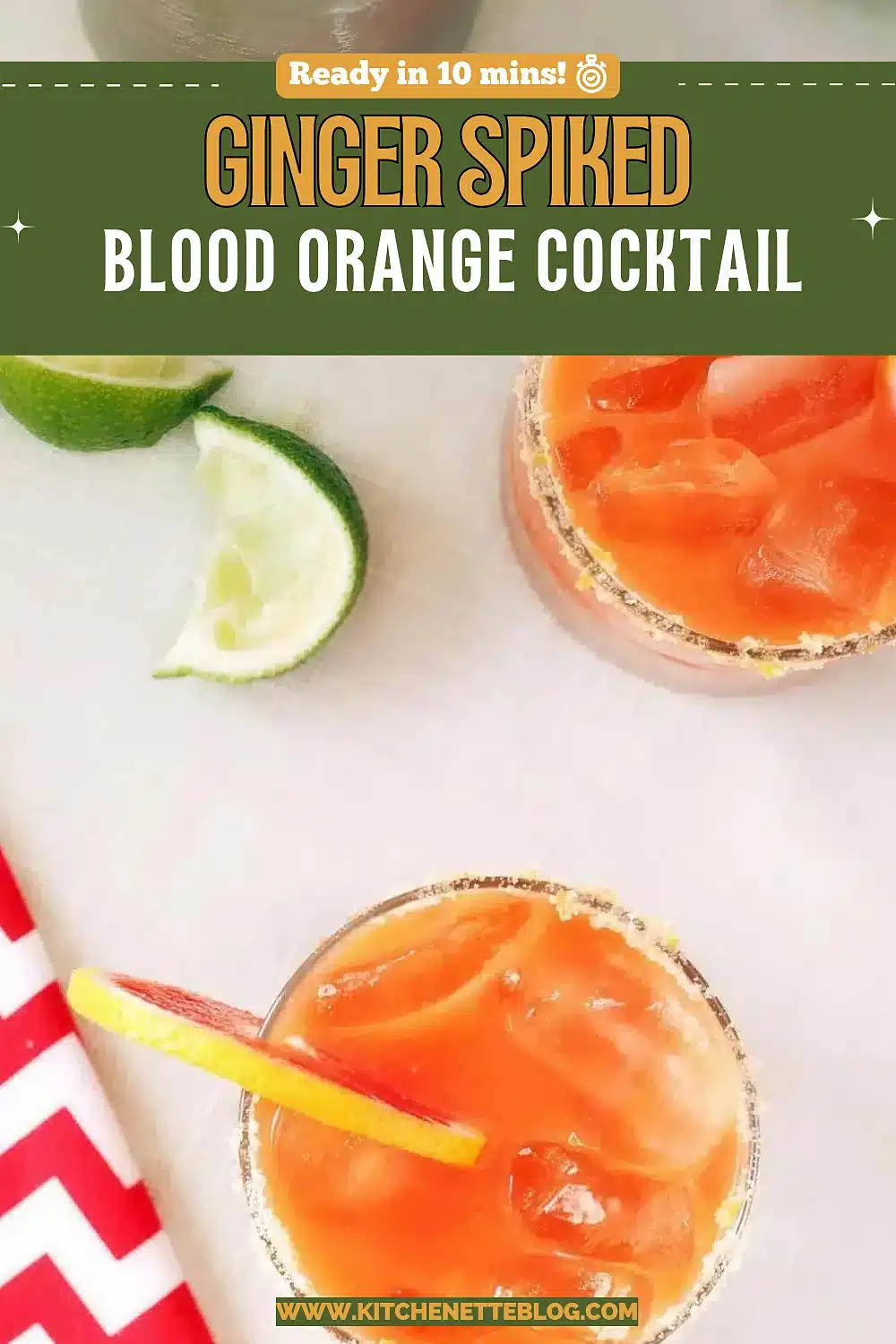 Two sugar-rimmed glasses of a red citrus drink over ice with lime wedges