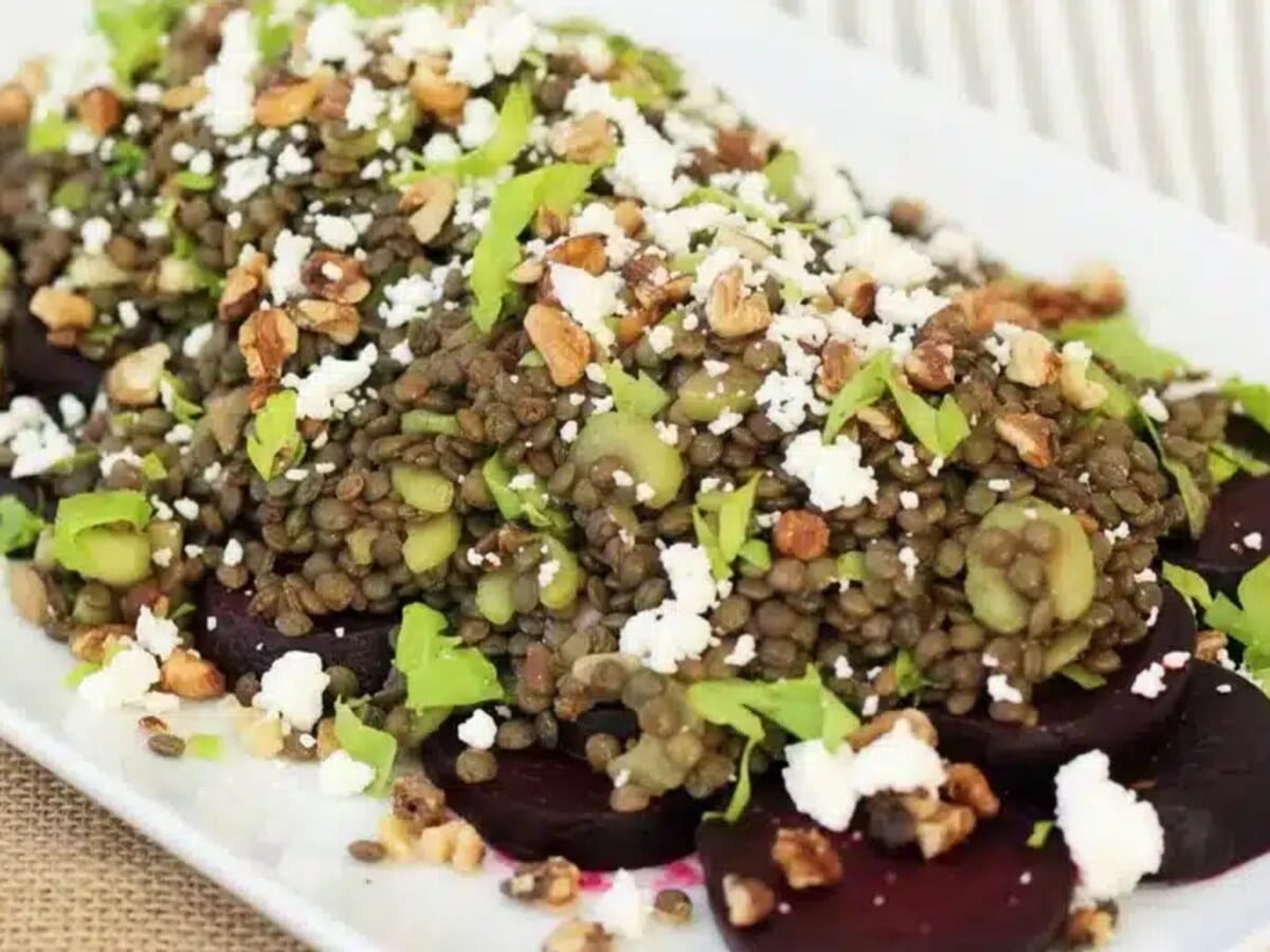 Beet lentil salad with feta and walnuts on a striped cloth