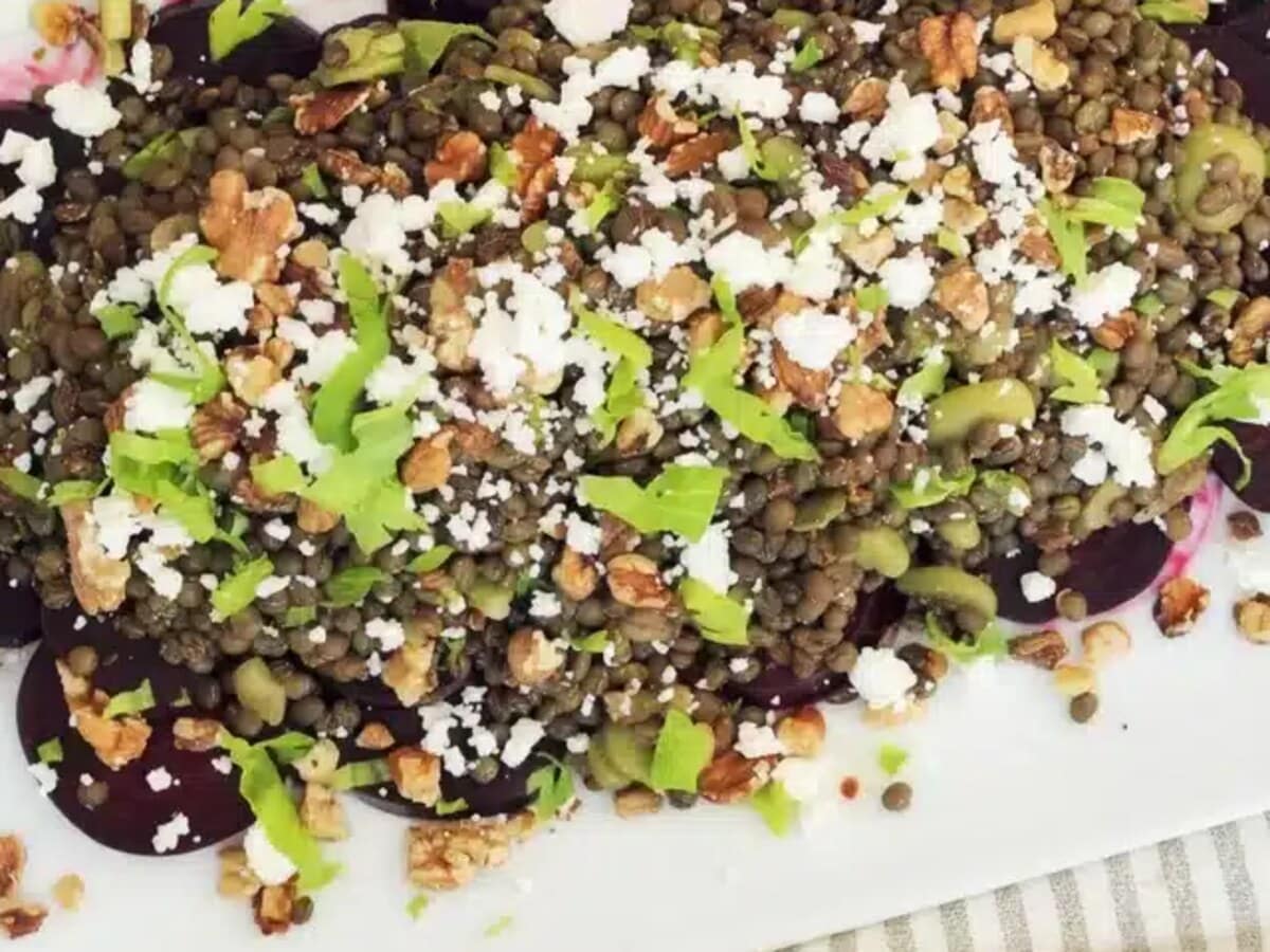 Close-up of crumbled feta, toasted walnuts and sliced celery