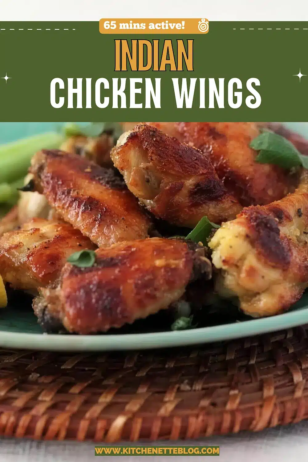 Deeply browned roasted wings piled on a pale teal plate with celery sticks and torn cilantro, on a woven rattan mat