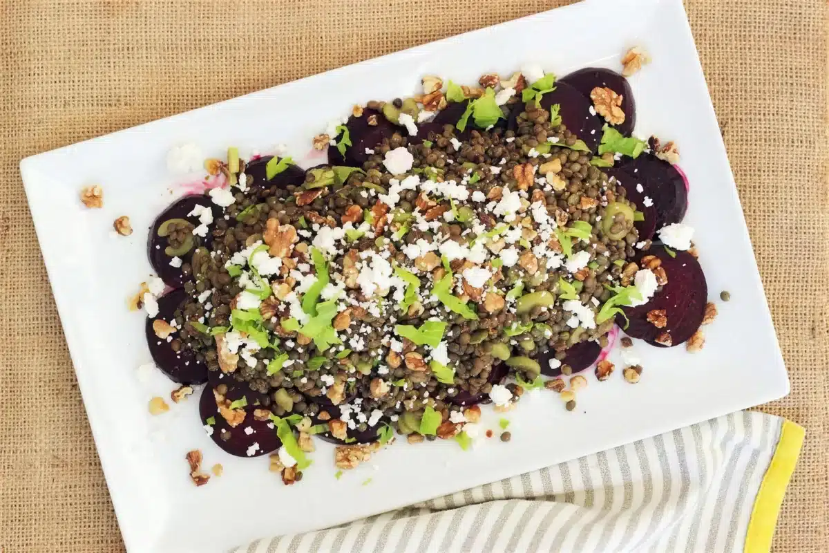 Beet lentil salad on a white platter seen from above