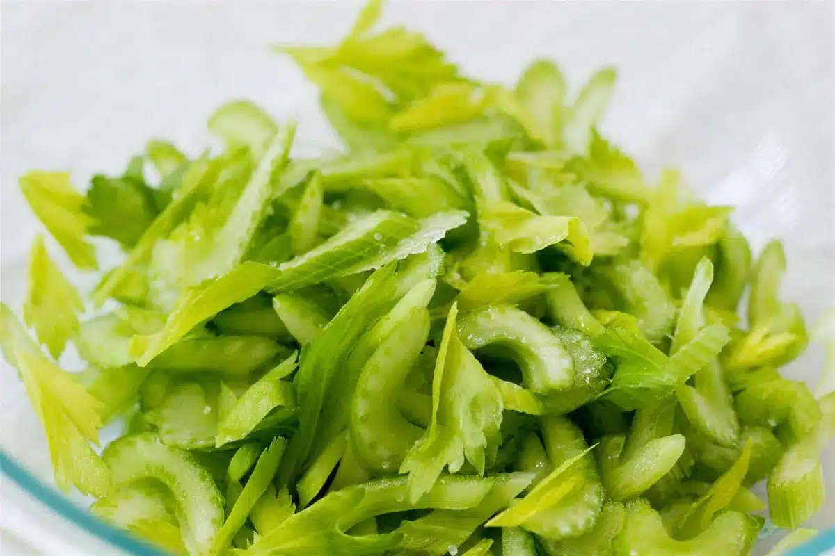 Pale green stalks sliced thin on a bias in a glass bowl