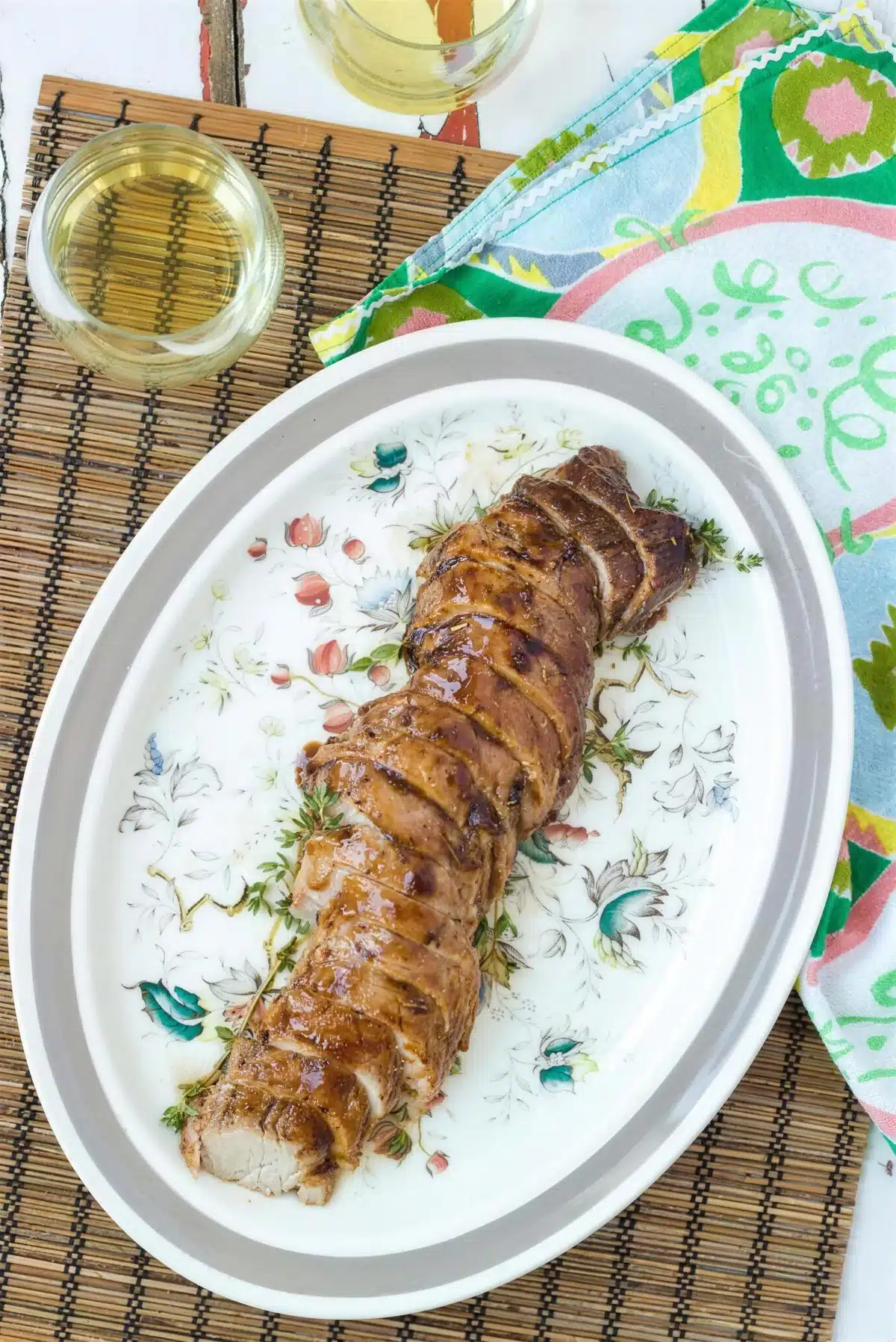 Balsamic pork tenderloin carved and served with extra sauce spooned over