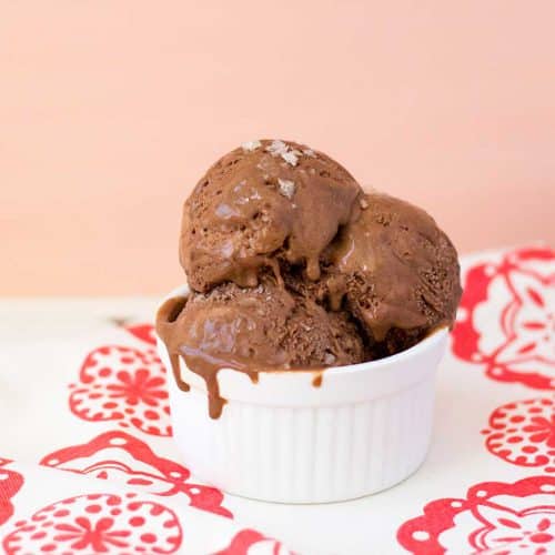 Chocolate caramel ice cream in a ramekin on a red print cloth