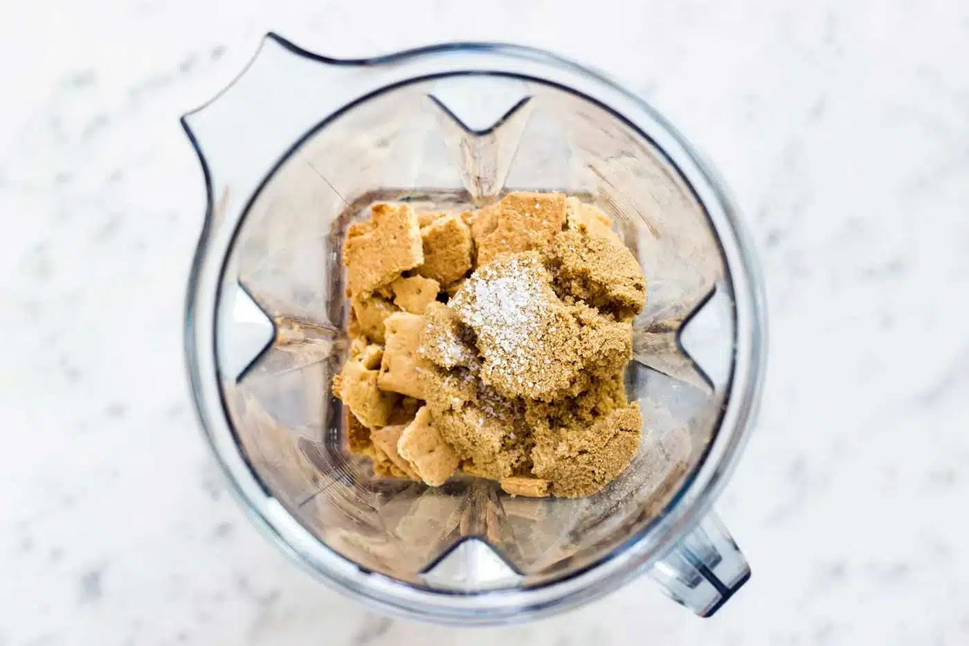Graham crackers and brown sugar in a blender jar before grinding