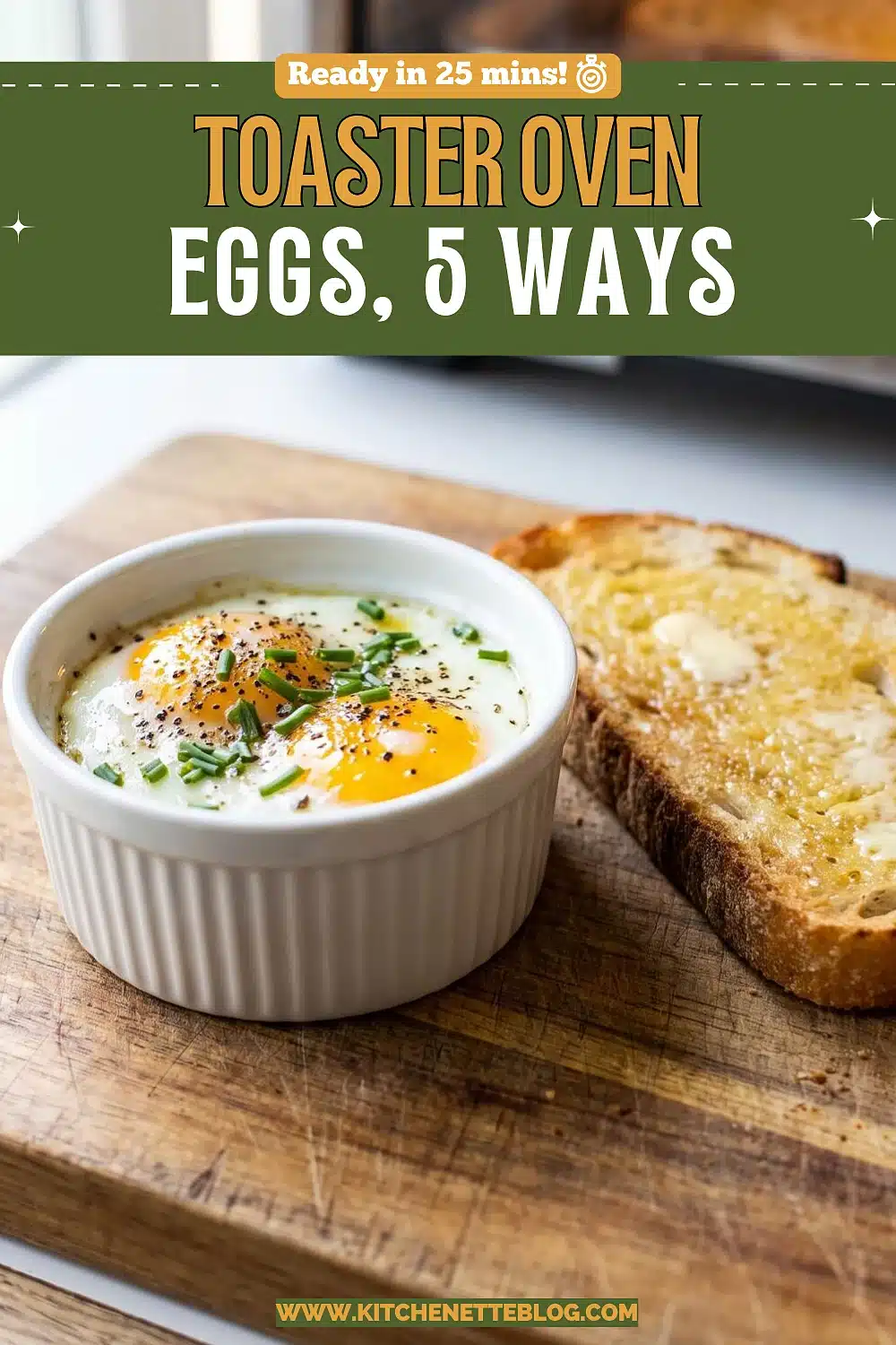 Two baked eggs with set whites and bright yolks in a white ramekin, sprinkled with chives and pepper, next to a slice of buttered toast on a wooden board