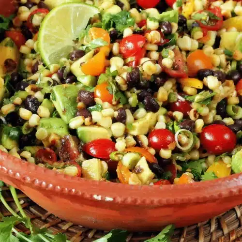 Close-up of black beans, diced avocado and halved cherry tomatoes