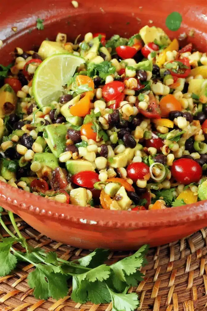 Close-up of black beans, diced avocado and halved cherry tomatoes