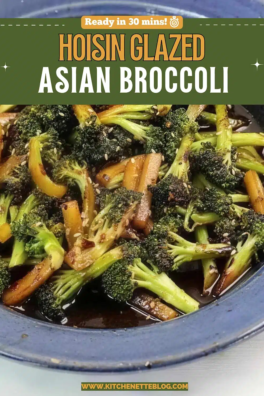 Charred broccoli florets and peeled stem batons in a dark glossy hoisin glaze in a blue stoneware bowl, scattered with sesame seeds