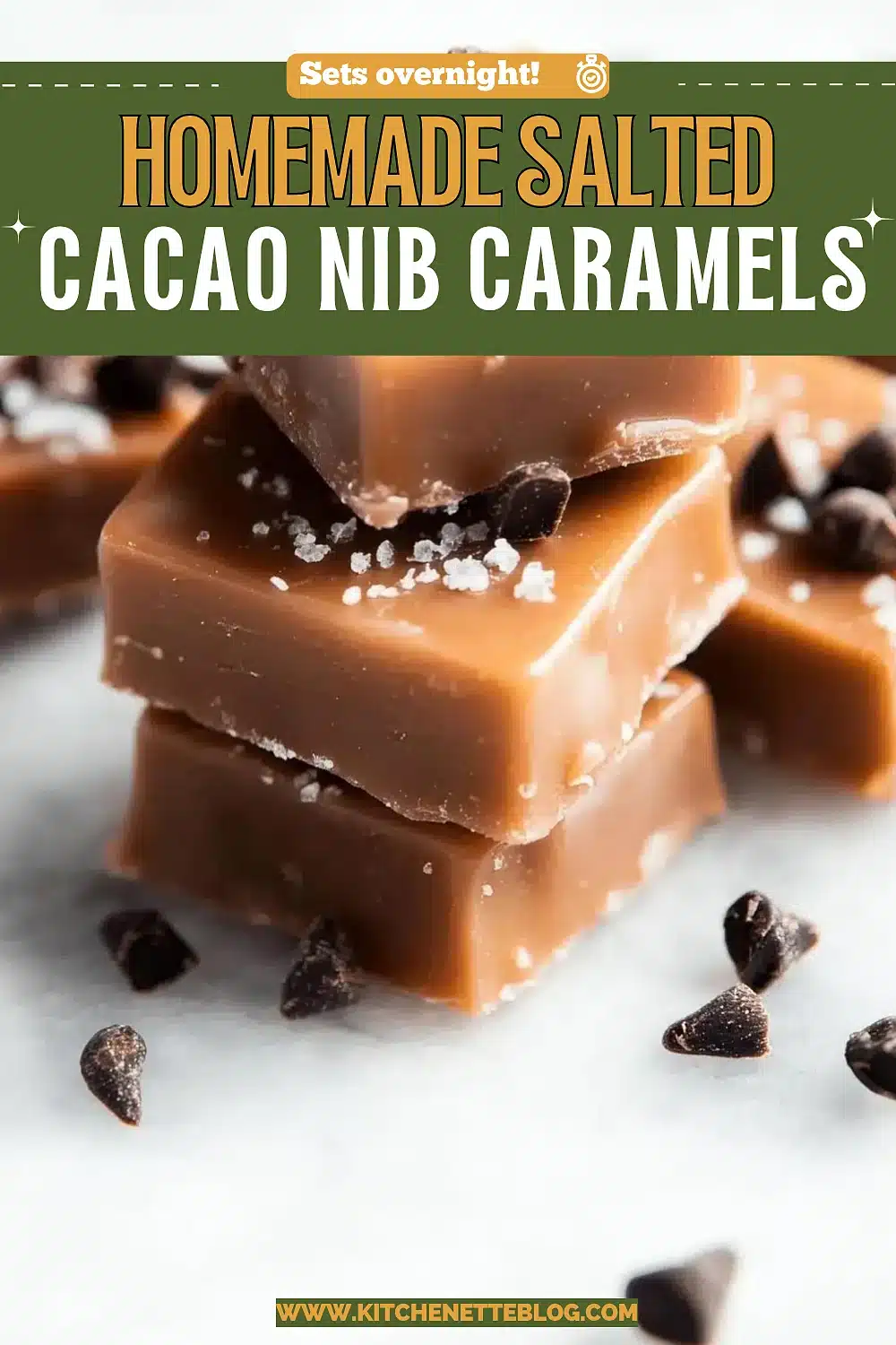 Stacked squares of chewy candy topped with flaky crystals and crushed cocoa