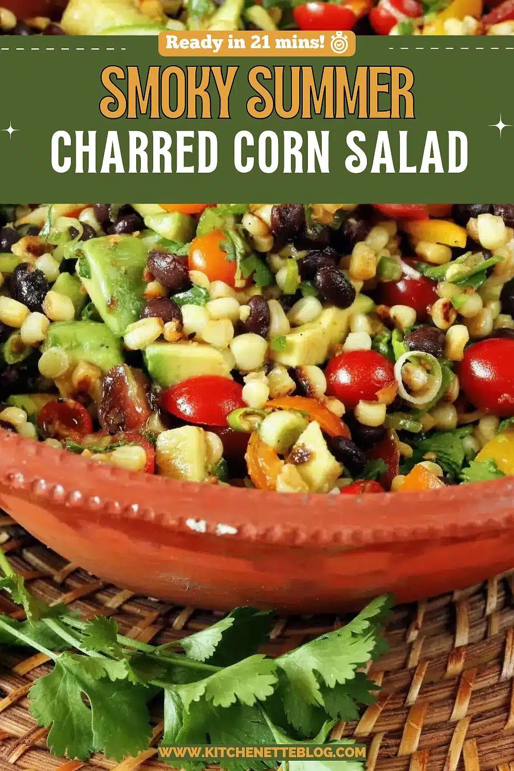 Terracotta bowl of avocado, black beans and cherry tomatoes with a lime wedge