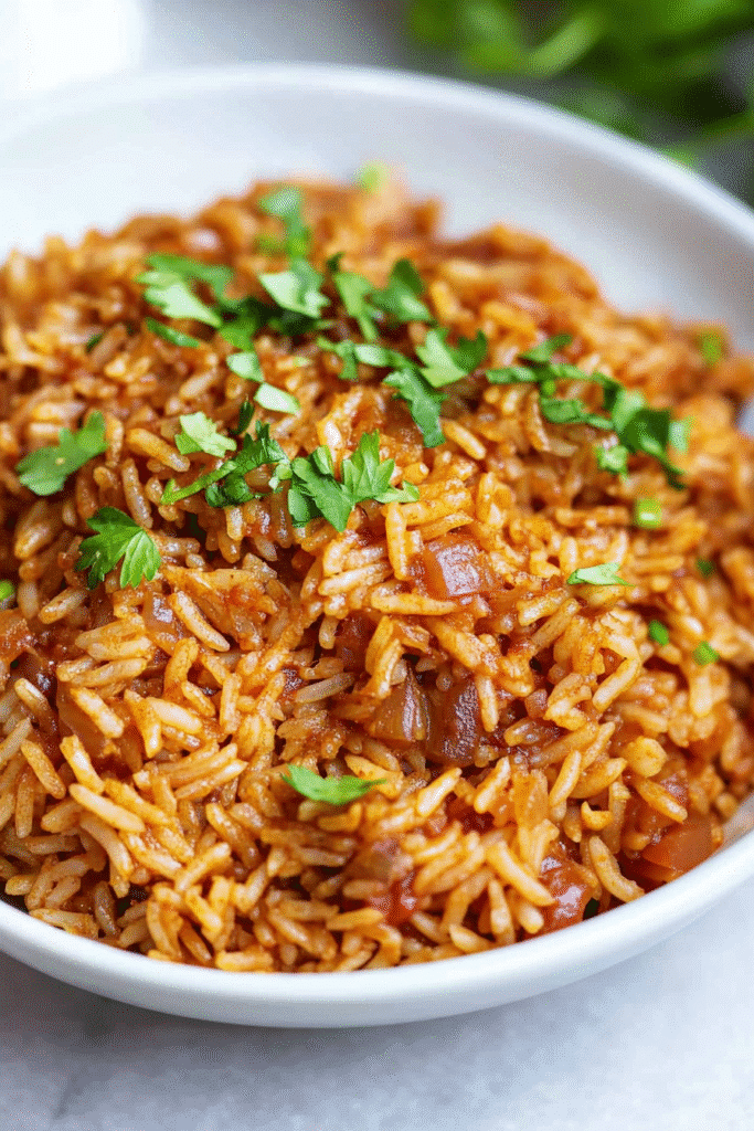 Bowl of buttery long-grain rice with visible seasoning.