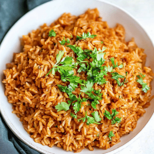 Golden seasoned rice pilaf with herbs in a serving bowl.