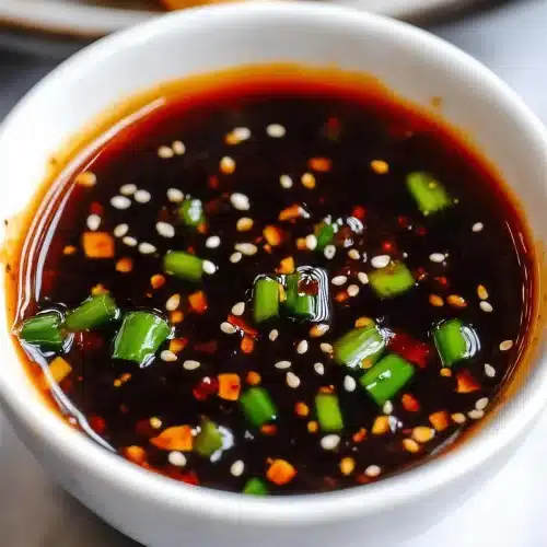 Iron Chef General Tso sauce on a spoon above a jar of the sauce