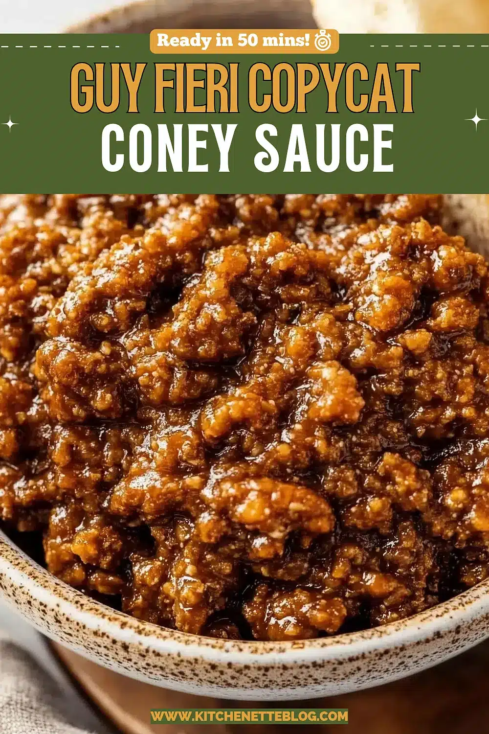 Bowl of dark simmered ground beef topping beside a soft roll