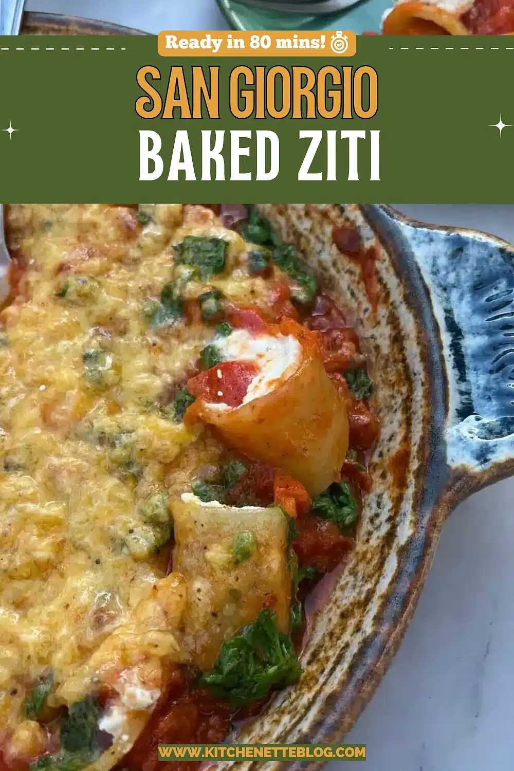 Browned melted cheese over pasta tubes and tomato sauce in a blue rimmed dish