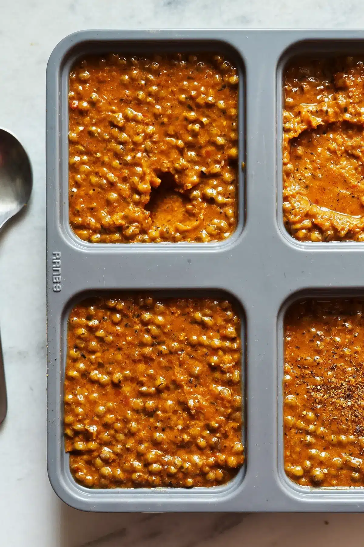 Lentil curry portioned into a silicone freezer mould