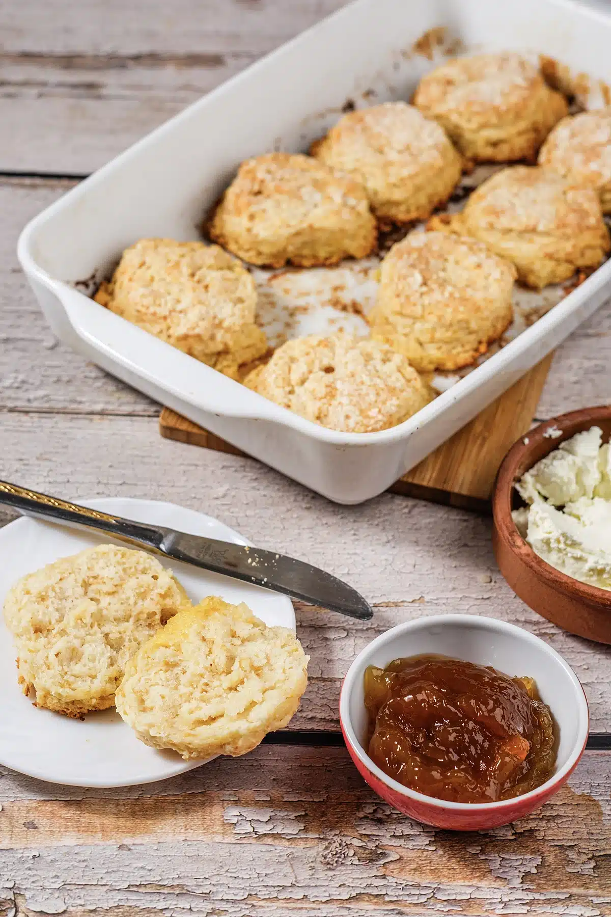 7Up biscuits in a white baking dish with one split open on a plate