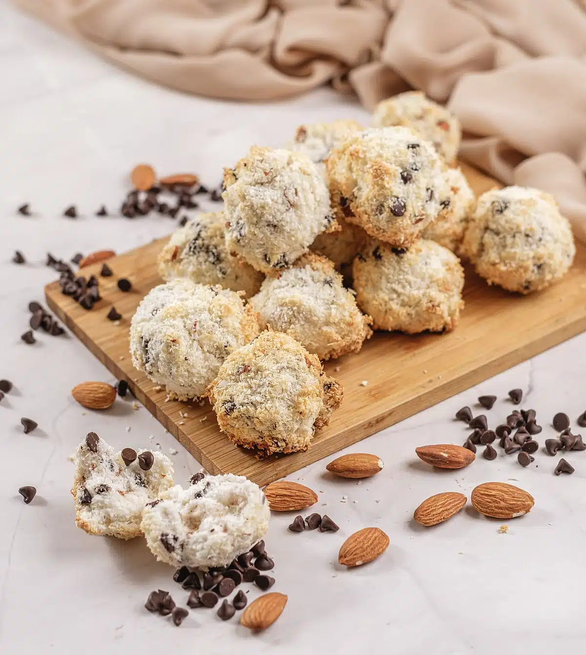 Almond Joy cookies on a wooden board seen from a low angle