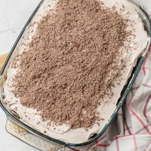 The whipped topping spread to the edges and covered with grated dark chocolate