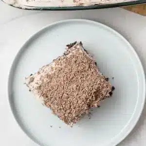 A single square of Baileys poke cake on a white plate