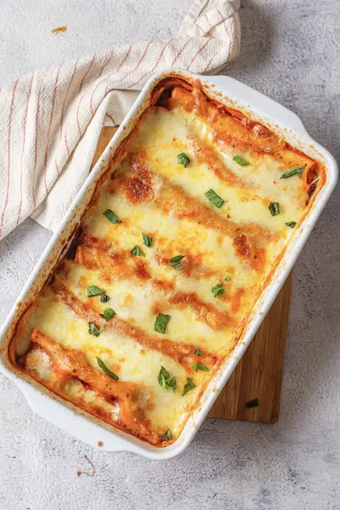 Baked manicotti seen from directly above in a white dish