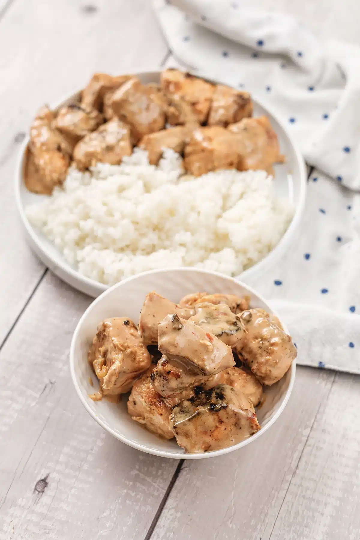 A close view of creamy sauce pooling over roasted fish pieces