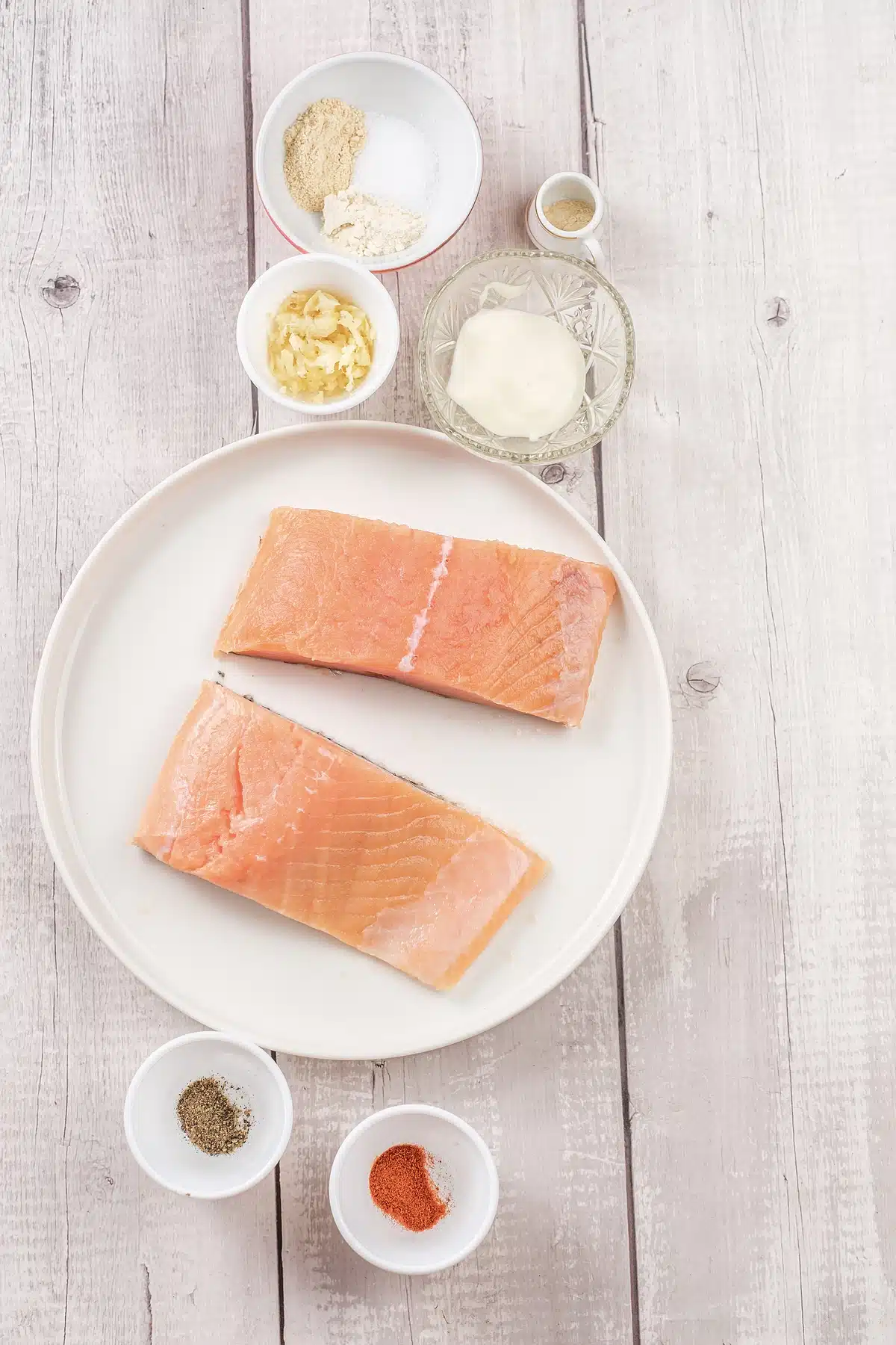 Bang bang salmon bites ingredients with two fillets, mayonnaise, garlic and paprika
