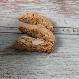 Three almond biscotti on a painted wooden table