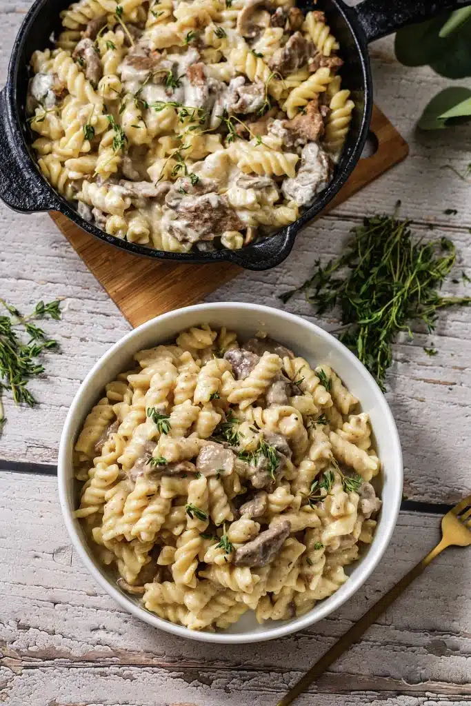 Beef stroganoff photographed from directly above in a white bowl