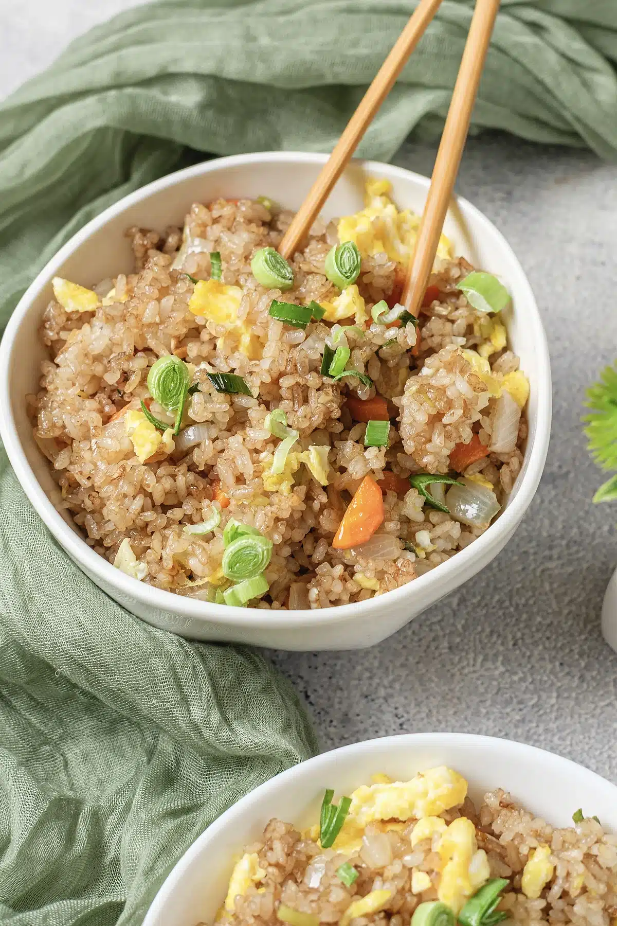Close overhead view of Benihana fried rice with scallions and chopsticks