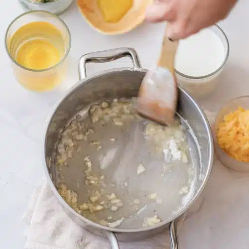 The flour and butter stirred into a pale roux with a wooden spoon