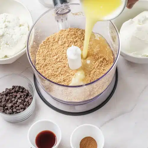 Melted butter poured over crumbs in a food processor