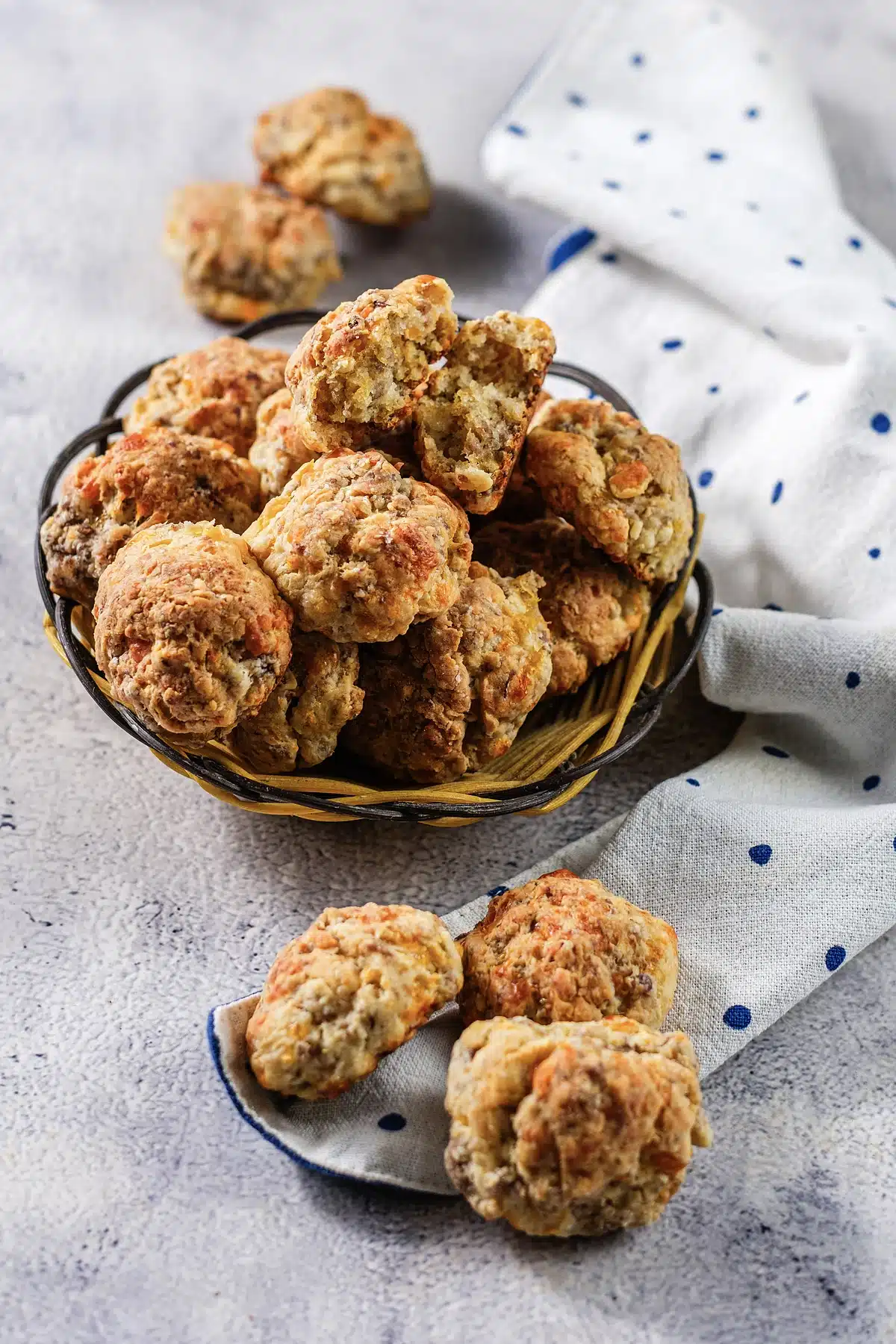 Red Lobster sausage balls in a wire basket with three tipped onto a napkin