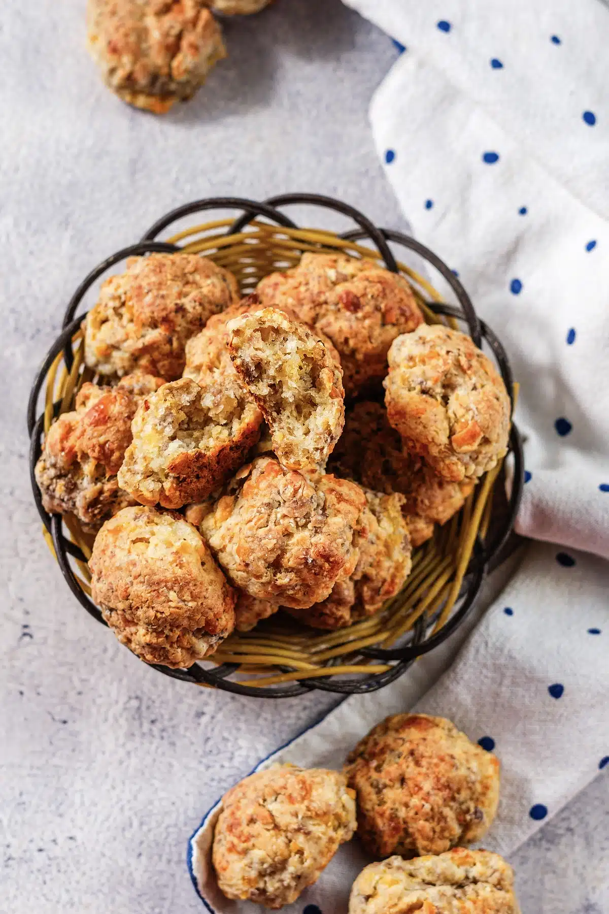 Craggy baked bites with melted cheese edges tumbling from a basket